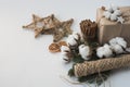 Christmas decorations eco cotton flowers, cinnamon,stars, spruce branches and jute rope hank over white background,holiday,xmas,ch Royalty Free Stock Photo