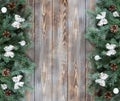 Christmas decorations with fir branches, silver balls and bows, cones on a wooden background. Flat lay, top view, copy space Royalty Free Stock Photo