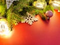 Christmas decorations. Fir, stars, balls and magic lights on red background . Atmospheric frame, place for text or your product. Royalty Free Stock Photo