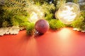 Christmas decorations. Fir, stars, balls and magic lights on red background . Atmospheric frame, place for text or your product. Royalty Free Stock Photo