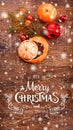 Christmas decorations with fir tree branch and tangerines on wooden background with snow, blurred Royalty Free Stock Photo