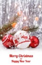 Christmas decorations with fir tree branch on wooden background with snow, blurred, sparking, glowing and text Merry Christmas Royalty Free Stock Photo