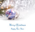 Christmas decorations with fir tree branch on wooden background with snow, blurred, sparking, glowing and text Merry Christmas Royalty Free Stock Photo