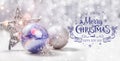 Christmas decorations with fir tree branch on wooden background with snow, blurred, sparking, glowing and text Merry Christmas Royalty Free Stock Photo