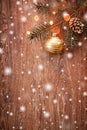 Christmas decorations with fir tree branch on wooden background with snow, blurred, sparking with space for text Royalty Free Stock Photo