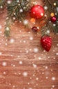 Christmas decorations with fir tree branch on wooden background with snow, blurred, sparking with space for text Royalty Free Stock Photo