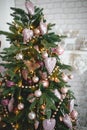 Christmas decorations on a fir tree close-up. Toys, cones, garlands with lights, balls, beads. New year, Royalty Free Stock Photo