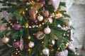 Christmas decorations on a fir tree close-up. Toys, cones, garlands with lights, balls, beads. New year, Royalty Free Stock Photo