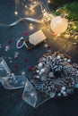 Christmas decorations, fur-tree branches, colorful balls, garlands, red and white glittering stars, christmas wreath on a dark Royalty Free Stock Photo