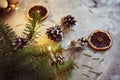 Christmas decorations with garland lights, pine cones and fir tree branch on a dark background Royalty Free Stock Photo