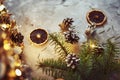 Christmas decorations with garland lights, pine cones and fir tree branch on a dark background Royalty Free Stock Photo