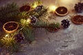 Christmas decorations with garland lights, pine cones and fir tree branch on a dark background Royalty Free Stock Photo