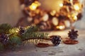 Christmas decorations with garland lights, pine cones and fir tree branch on a dark background Royalty Free Stock Photo