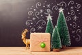 Christmas decorations and gift box over chalkboard background Royalty Free Stock Photo