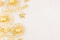 Christmas decorations, gold stars, balls and ribbons on soft white wooden background, copy space. Royalty Free Stock Photo