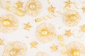 Christmas decorations, gold stars, balls and ribbons on soft white wooden background, pattern, top view. Royalty Free Stock Photo