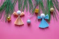 Christmas decorations. Green branches of pine-tree and paper Christmas angels on pink background. Copy space Royalty Free Stock Photo