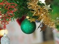Christmas decorations green tree hanging, green ball, socks, footwear, pink bell wrapped around it with a gold ribbon on white Royalty Free Stock Photo