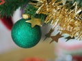 Christmas decorations green tree hanging, green ball, socks, footwear, pink bell wrapped around it with a gold ribbon on white Royalty Free Stock Photo