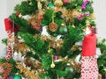 Christmas decorations green tree hanging, gold Gift box, green ball, brown Pine cones, socks, footwear, pink bell wrapped around Royalty Free Stock Photo