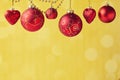 Christmas decorations hanging over golden bokeh background with copy space