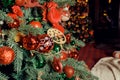 Christmas decorations on the holiday tree.Many colorful balls garland glowing lamps and red berries on the branches are Royalty Free Stock Photo