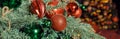 Christmas decorations on the holiday tree.Many colorful balls garland glowing lamps and red berries on the branches are Royalty Free Stock Photo