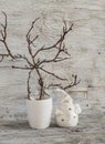 Christmas decorations home interior - dry branches in a white vase and a ceramic Santa Claus on a white wooden table