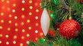Christmas decorations hung on a Christmas tree against a red background Royalty Free Stock Photo