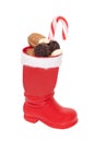 Christmas decorations isolated. Close-up of a red Santa Claus boots filled with nuts and other sweets isolated on a white Royalty Free Stock Photo