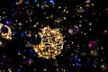 Christmas decorations with lights on a black background outside