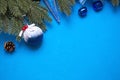 Christmas decorations made of artificial spruce, balloons with snow and berries, cones, bells, icicles on a blue background. New y Royalty Free Stock Photo