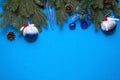 Christmas decorations made of artificial spruce, balloons with snow and berries, cones, bells, icicles on a blue background. New y Royalty Free Stock Photo