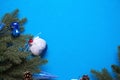 Christmas decorations made of artificial spruce, balloons with snow and berries, cones, bells, icicles on a blue background. New y Royalty Free Stock Photo