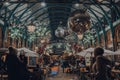 Christmas decorations, mistletoe and giant festive baubles in Covent Garden Market, London, UK