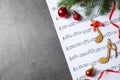 Christmas decorations, notes and music sheet on grey stone table, space for text Royalty Free Stock Photo