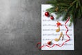 Christmas decorations, notes and music sheet on grey stone table, space for text Royalty Free Stock Photo