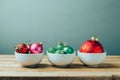 Christmas decorations and ornaments on wooden table. Three bowls with Christmas balls. Retro filter effect Royalty Free Stock Photo