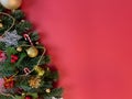 Christmas decorations, pine tree leaves, golden balls, snowflakes, golden berries and red berries on red background Royalty Free Stock Photo