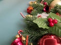 Christmas decorations, pine tree leaves, golden balls, snowflakes, golden berries and red berries on blue background Royalty Free Stock Photo