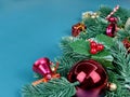 Christmas decorations, pine tree leaves, golden balls, snowflakes, red berries and golden berries on blue background Royalty Free Stock Photo