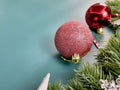 Christmas decorations, pine tree leaves, golden balls, snowflakes, red berries on blue background Royalty Free Stock Photo