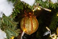 Christmas decorations. Real fir tree covered with snow. Christmas toy. Close-up