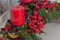 Christmas decorations with red candles and pine branch in white interior Royalty Free Stock Photo