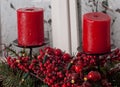 Christmas decorations with red candles and pine branch in white interior Royalty Free Stock Photo