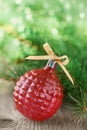 Christmas decorations with red Christmas ball and fir branches on wooden background with magic bokeh effect, Christmas card with Royalty Free Stock Photo