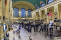 Christmas decorations red ribbon and wreath in the Grand Central Terminal and blurred people in Manhattan New York, USA