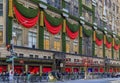 Christmas decorations red ribbons, wreaths and lights on the flagship Saks Fifth Avenue store in Manhattan New York, USA