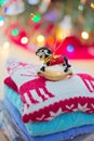 Christmas decorations rocking horse on a stack of sweaters in front of the Christmas tree