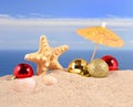 Christmas decorations seashells and starfish on a beach sand Royalty Free Stock Photo